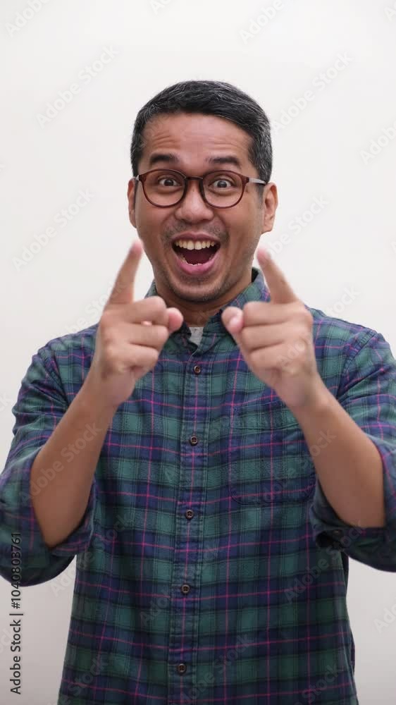 A man cheering and pointing at the camera and give thumbs up A man cheering and pointing at the camera and give thumbs up