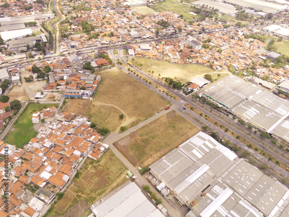 Fototapeta premium Aerial view of Industrial Building in Dwipapuri Industrial district, Rancaekek. Logistics center in industrial city zone from drone view. Background texture concept. Business and Economics