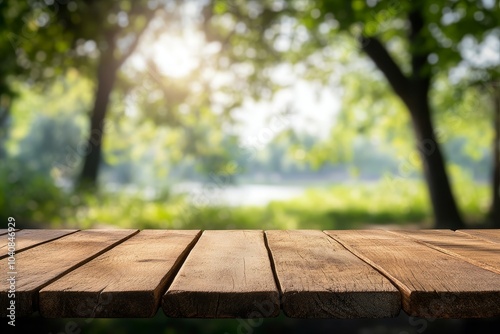 Wooden table top with a blurry background of a sunny green forest.