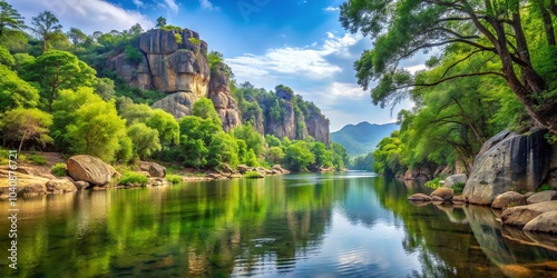 Tranquil River Winding Through Lush Forested Valley With Rugged Cliff Faces Reflecting In The Still Water