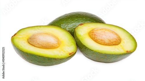 Two halves of a fresh avocado with the pit and a whole avocado on a white background.