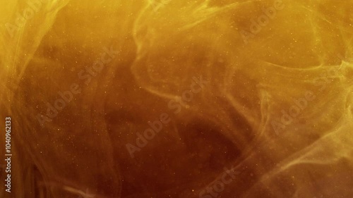 Sparkling smoke. Paint water splash. Defocused yellow bronze golden color vapor cloud shiny particles texture ink floating abstract art background.