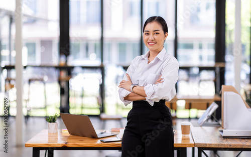 Asian Business woman using calculator and laptop for doing math finance on an office desk, tax, report, accounting, statistics, and analytical research concept 