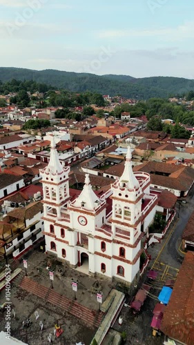 Vertical dronie shot of Mazamitla's church, capturing the townscape from above.