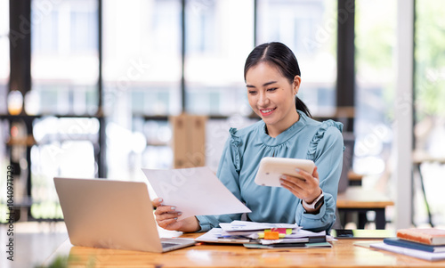 Wallpaper Mural asian business woman or auditor examining documents,Professional scrutinizes financial documents reports, detail-focused work concept
 Torontodigital.ca
