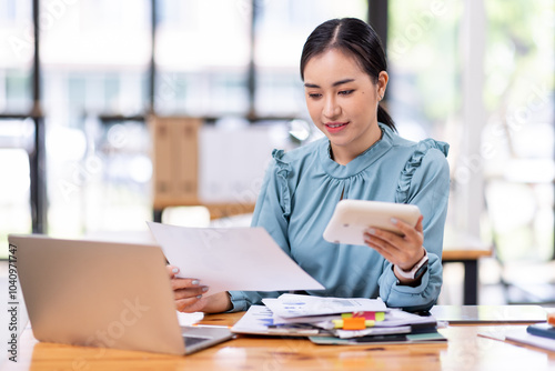 asian business woman or auditor examining documents,Professional scrutinizes financial documents reports, detail-focused work concept 