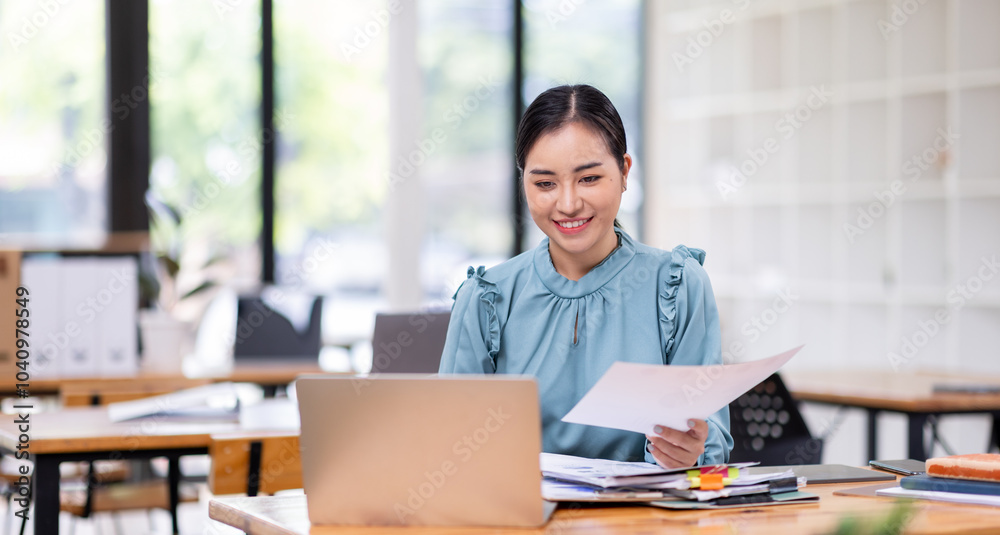 Fototapeta premium Business financing accounting banking concept. Business woman hand doing finances and calculate on desk about cost at home office. Woman working on desk with using calculator, finance accounting. 