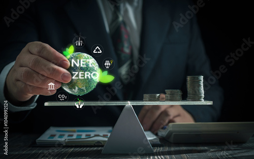 Business net zero carbon concept .Businessman hand balancing small Earth with 