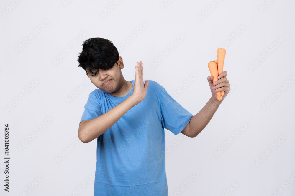 Young Indomesian man who looks scared and refuses to eat vegetables, concept of healthy lifestyle, campaign to eat healthy and nutritious vegetables, isolated white background. Young Indomesian man who looks scared and refuses to eat vegetables, concept of healthy lifestyle, campaign to eat healthy and nutritious vegetables, isolated white background.
