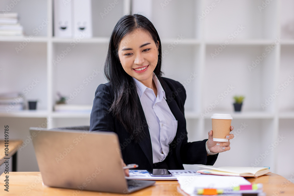 Portrait of Asian business woman holding coffee cup with work in workplace office Business documents money financial planning concept
Portrait of Asian business woman holding coffee cup with work in workplace office Business documents money financial planning concept