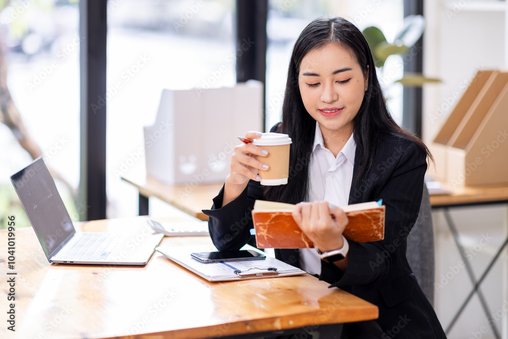 Portrait of Asian business woman holding coffee cup with work in workplace office Business documents money financial planning concept
Portrait of Asian business woman holding coffee cup with work in workplace office Business documents money financial planning concept