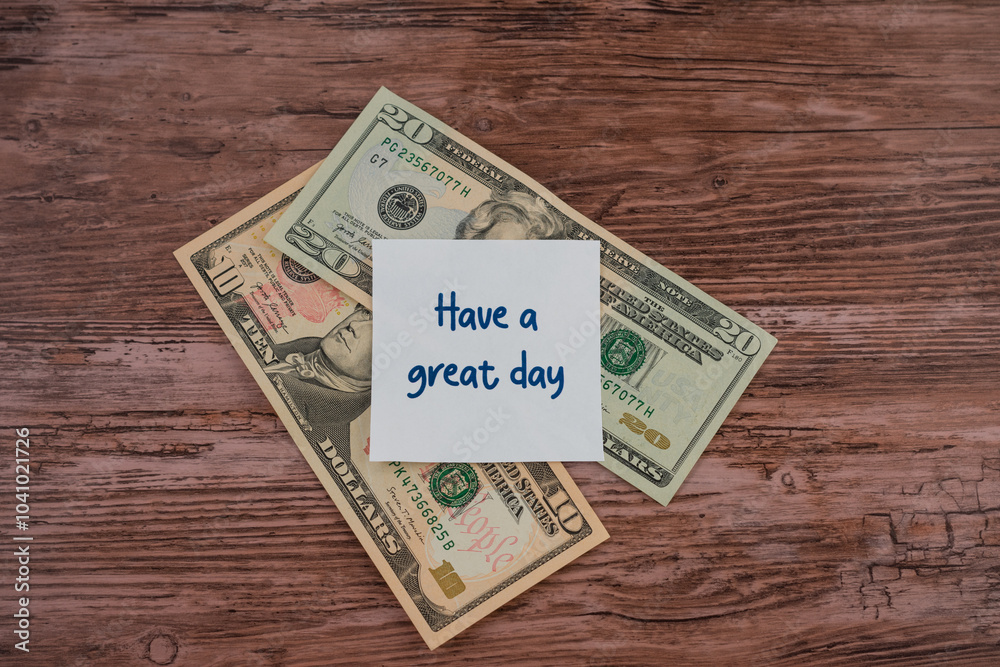 A stack of U.S. dollars with a note that says A stack of U.S. dollars with a note that says