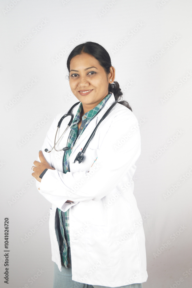 Cropped portrait of an attractive young female doctor standing with her arms folded in the office Cropped portrait of an attractive young female doctor standing with her arms folded in the office