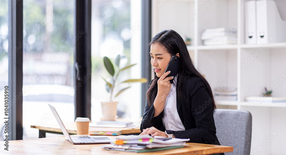 asian woman talking on the phone while working on computer in desk office. Searching on internet
asian woman talking on the phone while working on computer in desk office. Searching on internet