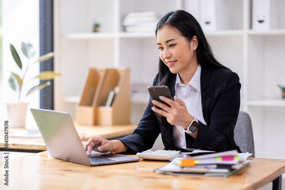 Portrait of a happy Asian businesswoman using mobile phone indoor, Asian businesswoman working in modern office.
Portrait of a happy Asian businesswoman using mobile phone indoor, Asian businesswoman working in modern office.