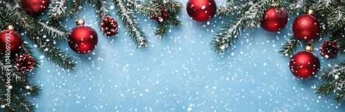 Christmas banner with evergreen branches and red ornaments, snowy background Banner.