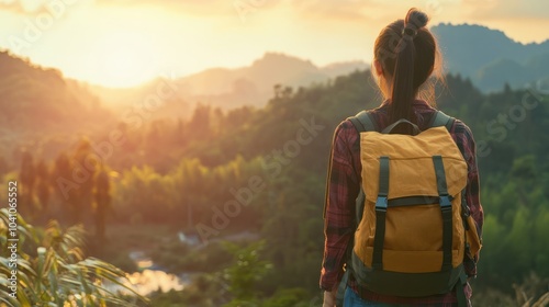 An Asian girl with a backpack is seen in nature at sunset embodying a relaxed holiday vibe with a hipster style color tone and selective focus on a copy space image