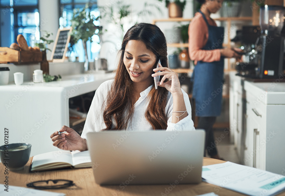 © peopleimages.com - Creative woman, laptop and phone call in coffee shop meeting for startup, artist or small business agency. Designer, notes and art director happy for project proposal, planning or entrepreneur goals