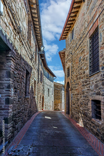 Obraz na płótnie The narrow alleyways of Collemancio reveal beautifully preserved medieval architecture set against the backdrop of a clear blue sky in Umbria. Village Collemancio - Italian national heritage w salonie