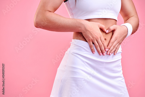 Wallpaper Mural Woman, fitness and body with heart hands in studio for weight loss, digestion and gut health. Slim, abdomen and person with love emoji on stomach for diet, progress and self care by pink background Torontodigital.ca