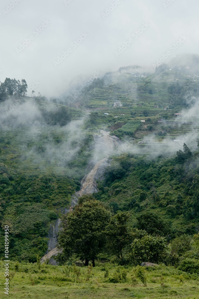 Fototapeta premium Misty Mountain Landscape with Waterfall