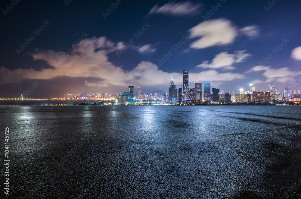 Asphalt road square and city skyline with modern buildings scenery at night in Shenzhen. car advertising background.