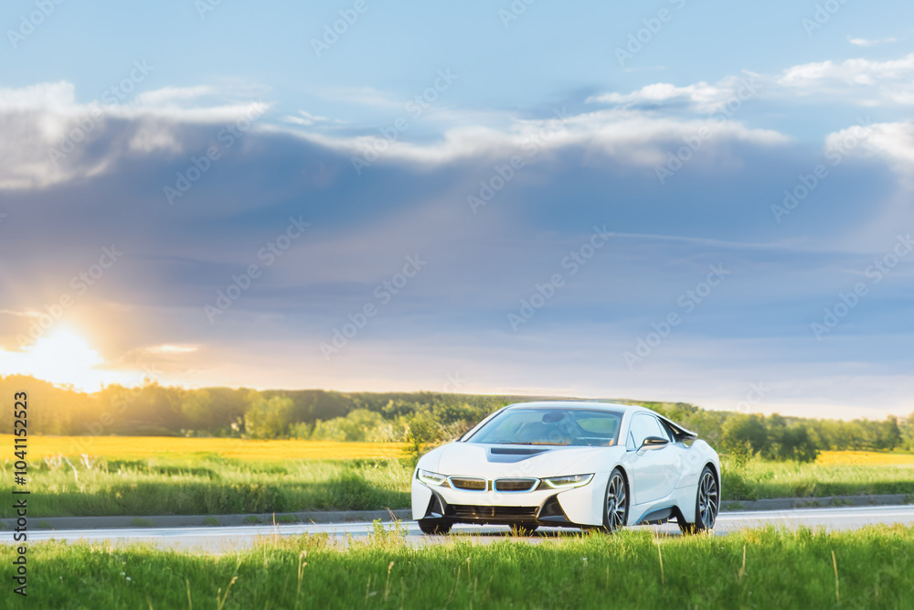 Sustainable sports car on scenic countryside drive Sustainable sports car on scenic countryside drive