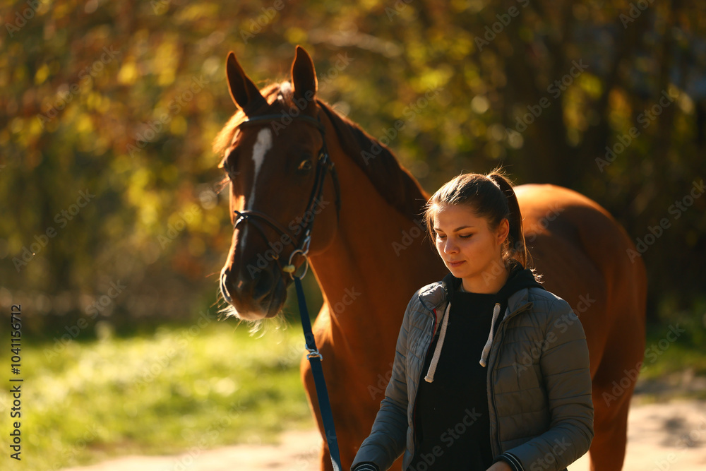 Obraz premium Girl and her horse walking around the ranch