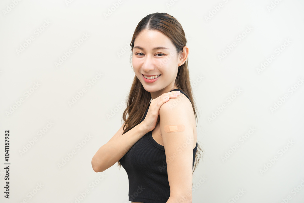 Healthcare of Covid-19, corona anti virus vaccination, happy asian young woman hand showing at bandage, plaster on her arm, getting vaccine immunity, giving injection influenza to protection pandemic. Healthcare of Covid-19, corona anti virus vaccination, happy asian young woman hand showing at bandage, plaster on her arm, getting vaccine immunity, giving injection influenza to protection pandemic.