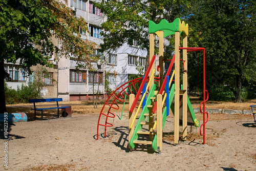 Summer spring children's playground with painted toy slide in park