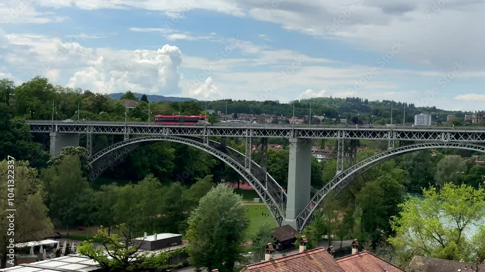 Aerial wide shot of Kirchenfeldbrücke Bridge in Bern between old town and casino square. Green trees in summer of Switzerland. Metal bridge with traffic on. Aerial wide shot of Kirchenfeldbrücke Bridge in Bern between old town and casino square. Green trees in summer of Switzerland. Metal bridge with traffic on.