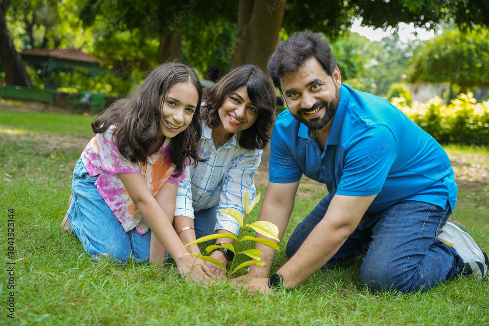 happy young indian family planting tree. concept of environmental conservation, save planet and sustainable lifestyle. Earth day, happy young indian family planting tree. concept of environmental conservation, save planet and sustainable lifestyle. Earth day,