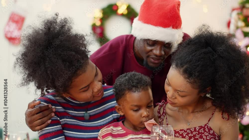 African family embracing and sharing moment together during celebrating on festive Christmas party at home. Love and togetherness on holidays African family embracing and sharing moment together during celebrating on festive Christmas party at home. Love and togetherness on holidays
