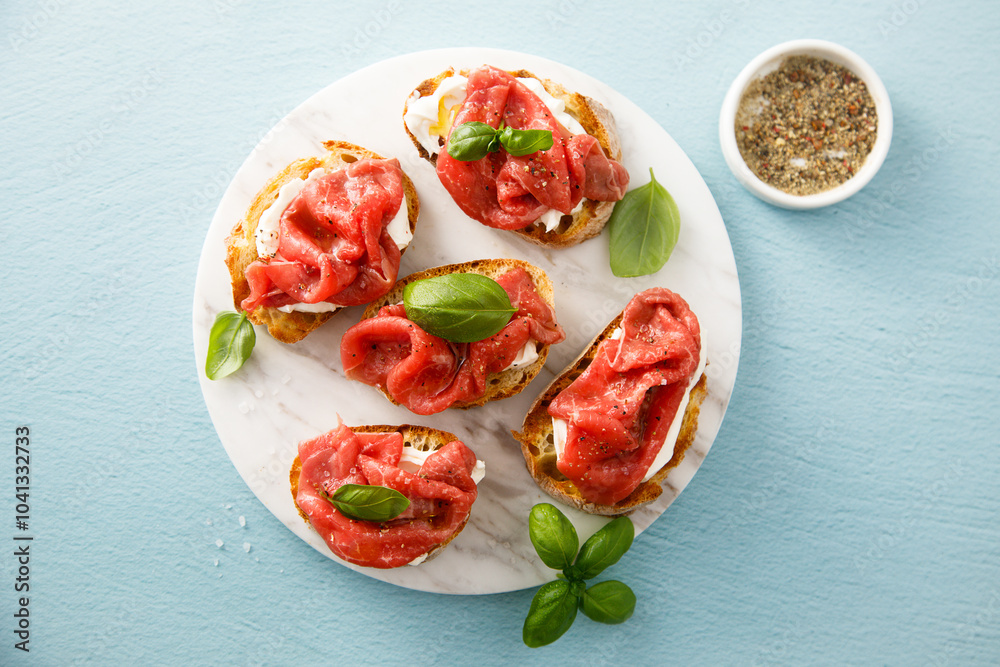 Crostini with beef carpaccio Crostini with beef carpaccio