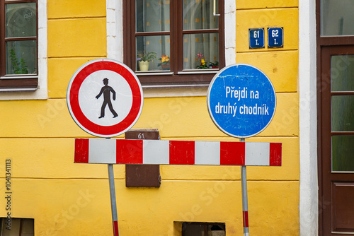 Czechia road signs with pedestrian warning and direction to cross on another sidewalk in czech 