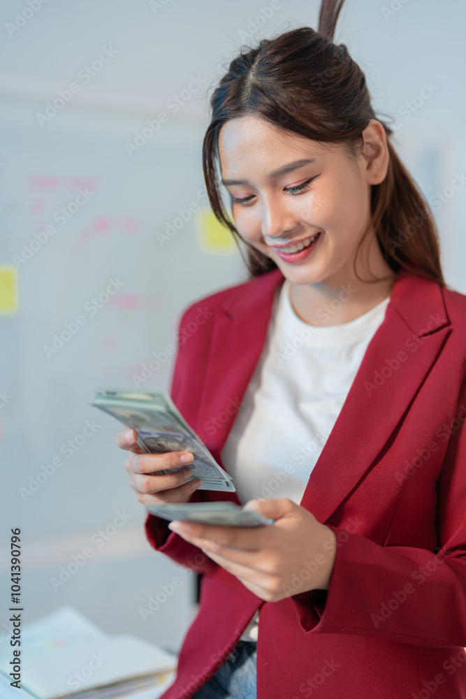 Happy businesswoman counts us dollars in her stylish office, radiating confidence and success. She smiles, surrounded by paperwork and opportunities for growth Happy businesswoman counts us dollars in her stylish office, radiating confidence and success. She smiles, surrounded by paperwork and opportunities for growth