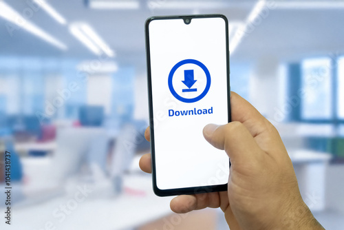 Close-up of “Download” message on smartphone screen. Online file download concept. Office background. Download message. 