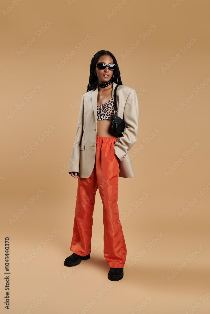 Fototapeta premium A young woman exudes confidence in a trendy ensemble, showcasing her unique style.