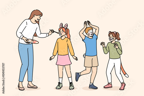 Children party dedicated to animals, with face painting for boys and girls from caring woman artist. Happy children rejoice with painted faces for themed party or masquerade on eve of animal day