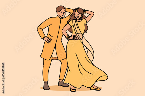 Indian couple performs ritual mating dance, moving rhythmically to oriental music. Newlyweds in indian national clothes dance while performing in front of audience at ethnic festival