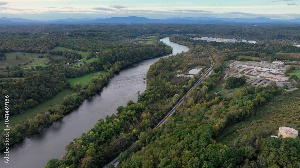 River landscape of USA with highway and mountains at horizon. Aerial wide shot. Dense woodland in autumn. Drone wide shot. River landscape of USA with highway and mountains at horizon. Aerial wide shot. Dense woodland in autumn. Drone wide shot.
