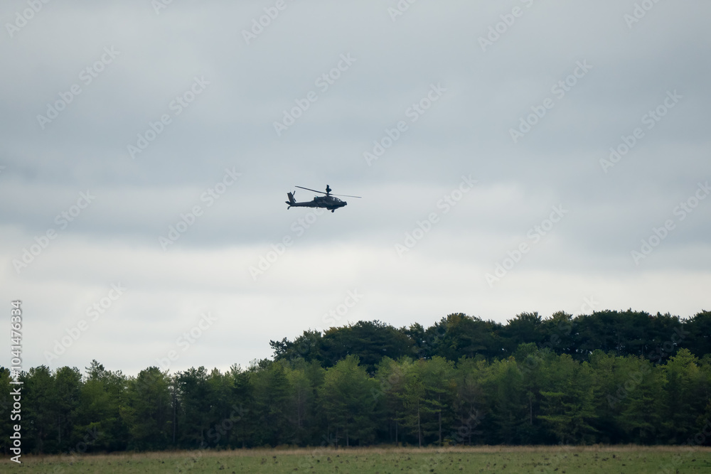 British army Boeing Apache Attack helicopter gunship AH2 AH64E AH-64E ArmyAirCorp in low level flight over countryside British army Boeing Apache Attack helicopter gunship AH2 AH64E AH-64E ArmyAirCorp in low level flight over countryside