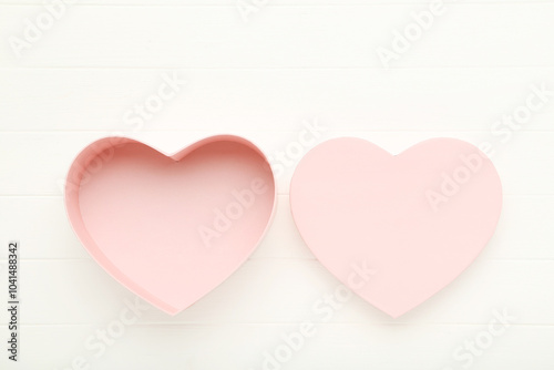 Heart shaped gift box on white wooden table