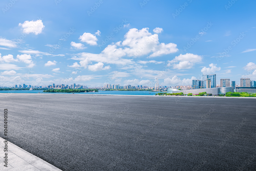 Fototapeta premium Empty asphalt road and cityscape with skyline in modern city