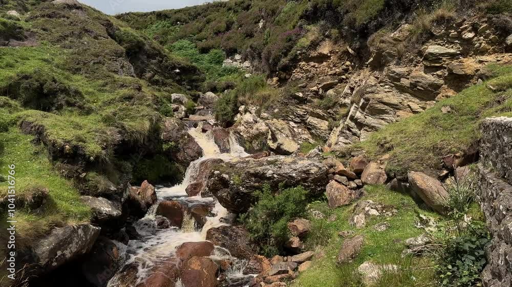 Rain water flowing from small cliff as waterfall Rain water flowing from small cliff as waterfall