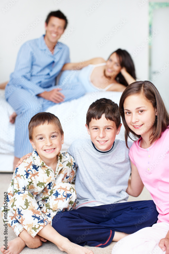Bedroom, pajamas and portrait of happy kids with siblings in home for support, love or wellness. Weekend, mother or father with boys, children and family for bonding together with parents in morning Bedroom, pajamas and portrait of happy kids with siblings in home for support, love or wellness. Weekend, mother or father with boys, children and family for bonding together with parents in morning