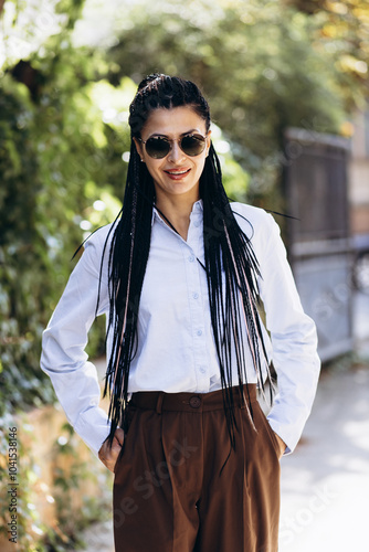 Young woman with braided hair walking in the street