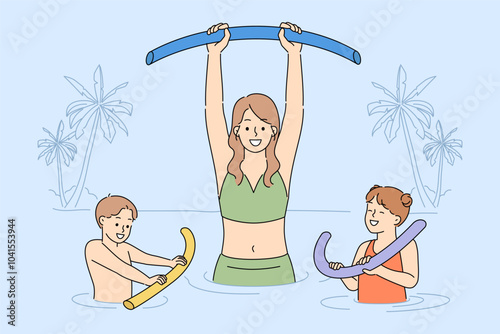 Water aerobics for family of mother and joyful children relaxing in pool on seashore