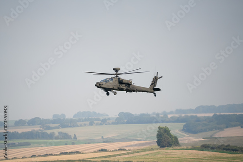 close-up side view of a British army Boeing Apache Attack helicopter gunship AH64E AH-64E ArmyAirCorp in low level flight