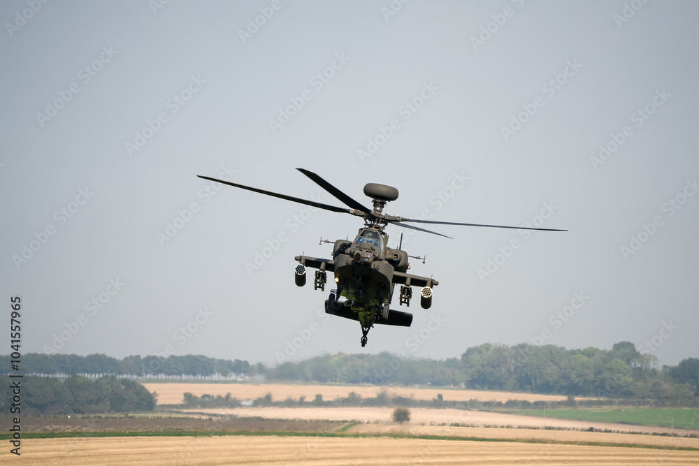 close-up front view of a British army Boeing Apache Attack helicopter gunship AH64E AH-64E ArmyAirCorp in low level flight close-up front view of a British army Boeing Apache Attack helicopter gunship AH64E AH-64E ArmyAirCorp in low level flight